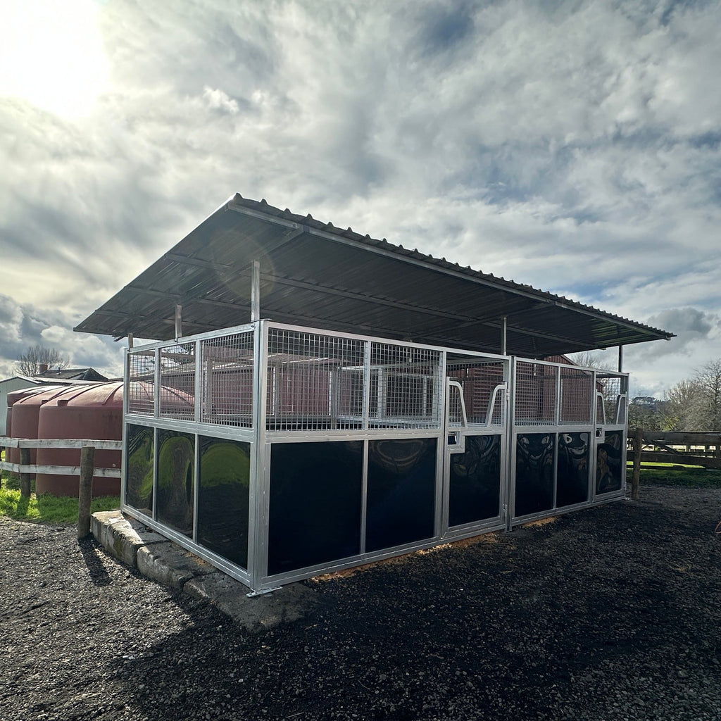 modular horse stable with roof installed on a gravel yard, front corner exterior view
